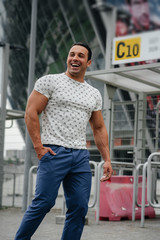 A sports guy stands and enjoys a walk near the stadium. Lifestyle