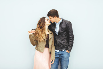 Happy loving couple isolated on gray background. stylish image, good mood, kiss in love