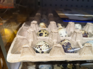 Quail egg in egg container wrapped with food film on sale in large mall