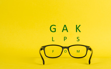 Nearsightedness depicted with glasses and blurred letters