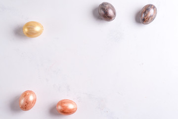 Beautiful Easter silver and gold eggs on marble background