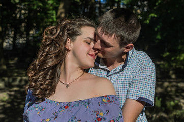 Young couple in love hugs and kisses