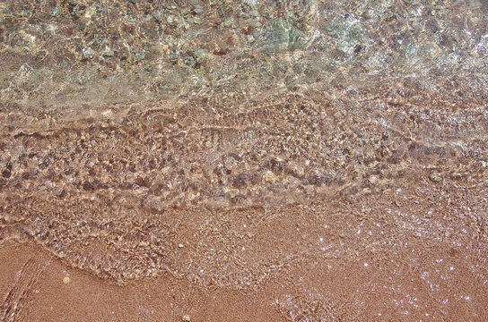 Background of the seabed. Sea stones, clear water and beautiful glare. Seaside