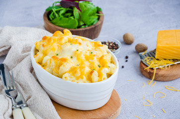 Mac and cheese. Traditional baked macaroni with cheese in baking form. American cuisine. Horizontal orientation.