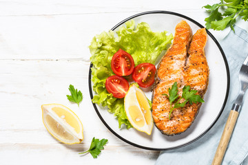 Grilled salmon fish steak on white.