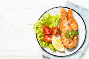 Grilled salmon fish steak on white.