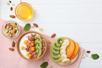Yogurt with fruits, granola and nuts on the table top view. Healthy breakfast, natural yogurt.