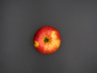 top view of an red and yellow apple on a dark background