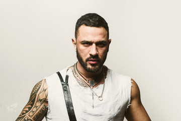 Obraz premium Close up portrait of handsome guy . Close up face of fashionable latin man on grey background.