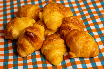 Several mini croissants on a tablecloth