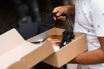 Shuriken throwing star, traditional japanese ninja cold weapon stuck in surprise box for man birthday. Throwing knives, mini axes set. Hunting concept.