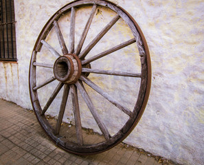 wagon wheel against a wall
