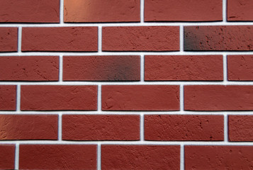 Fototapeta na wymiar Background brick wall . Red brick white seams.