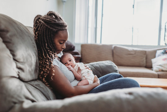 Infant cuddled on ethnic mother?s chest