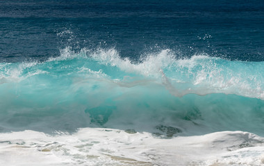 Frozen motion of water droplets at the crest of ocean waves off the coast of Hawaii