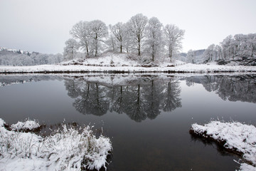 Refelctions in the River Brathay after an overnight fall of snow in the Langdale Valley, Lake District, UK. Taken on 17th January 2016.
