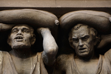 Pair of atlantes holding  neo-gothic facade