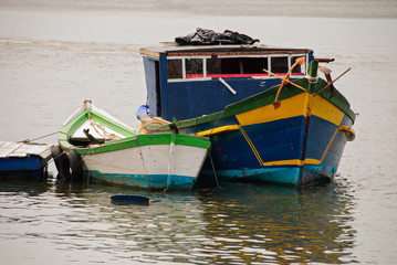 hing boats anchored in the river, floating peacefully in harbor.