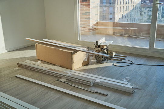 Spacious empty floor living room with a stack of boxes and reform tables. Housing preparing to furnish