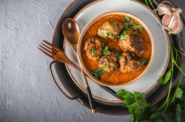Tasty homemade meatballs with tomato sauce and herbs served in a plate