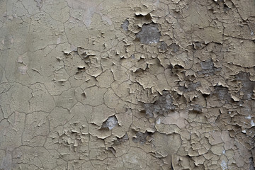 peeling beige paint on an old concrete wall. background