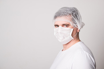 Doctor in a medical mask and hat. Man in a medical mask. Doctor man in a medical mask.