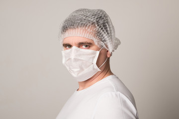 Doctor in a medical mask and hat. Man in a medical mask. Doctor man in a medical mask.