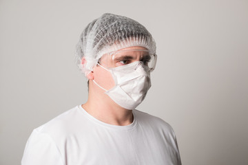 Male doctor in a surgical mask and glasses. Surgeon before the operation. Young man in a medical mask.