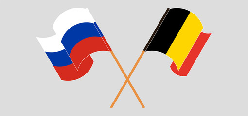 Crossed and waving flags of Belgium and Russia