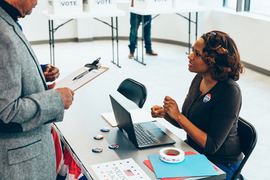 Volunteer helping voters at polling place