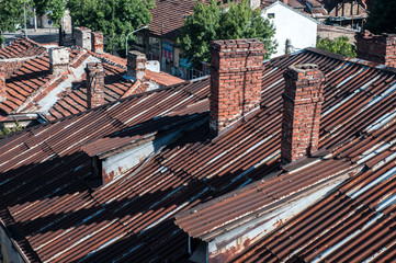 Weathered vintage rusty corrugated tin house roof clpseup in sunny day