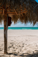 Fototapeta na wymiar Thatched umbrellas on the beautiful beach of Varadero in Cuba