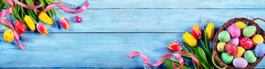 Easter - Painted Eggs In Basket With Tulips On Blue Plank