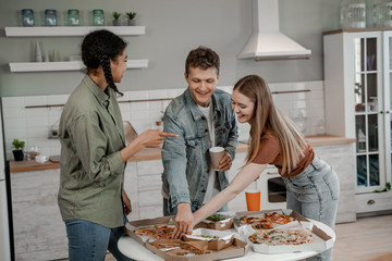 Food delivery home concept, party with tasty and junk food, friends celebrate together. International friendship, happy time together, friends having relax time. Enjoy communication and holiday.