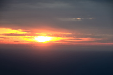 Fototapeta na wymiar Rising sun over the sea. Beautiful clouds. The morning sun illuminates the clouds with light