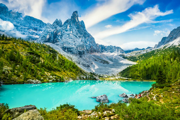 Famous turquoise lake Sorapis with high mountains at sunset, Dolomites, Italy, Europe