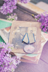 Traditional medal on which is written in Russian-For Bravery on old books 9 May Victory day concept...