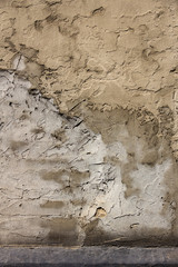 Gray concrete in dirty drips. The wall of the old building. Vertical photo