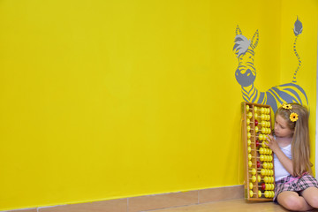 little girl with a wreath on her head and an abacus,