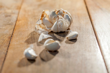 Organic raw garlic bulb on a wooden surface