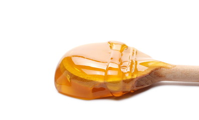 Honey with wooden spoon isolated on white background