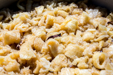 Fish maw soup in a big saucepan. ฺBraised fish maw with red gravy sauce in big pan on market. Close up of braised fish maw in red gravy.