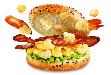 Fried bacon avocado cheese egg salad  bagel on a white isolated background