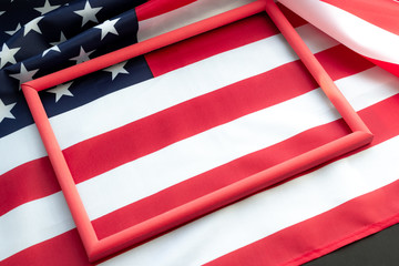 Flag of USA on black background with copy space in red frame. Concept of the patriotic holidays