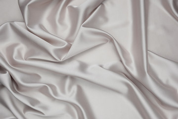 Beige luxurious satin fabric texture for background