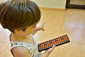 baby and abacus on a yellow background