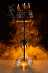 Stylish hookah in a pineapple for guests. Pineapple hookah. Hookah lounge