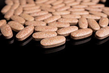 Pills on a black background at the top of the frame, place for text.