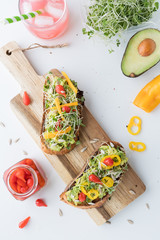 flat lay of two avocado toasts topped with Peruvian peppers ready for eating.
