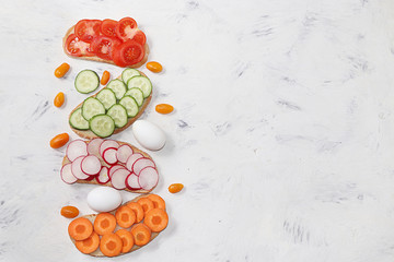 Useful breakfast, fried bread, carrots and cucumbers, tomatoes and radishes, eggs, green sandwiches, fermented foods, the concept of a healthy diet and weight loss, diet mini-sandwiches 